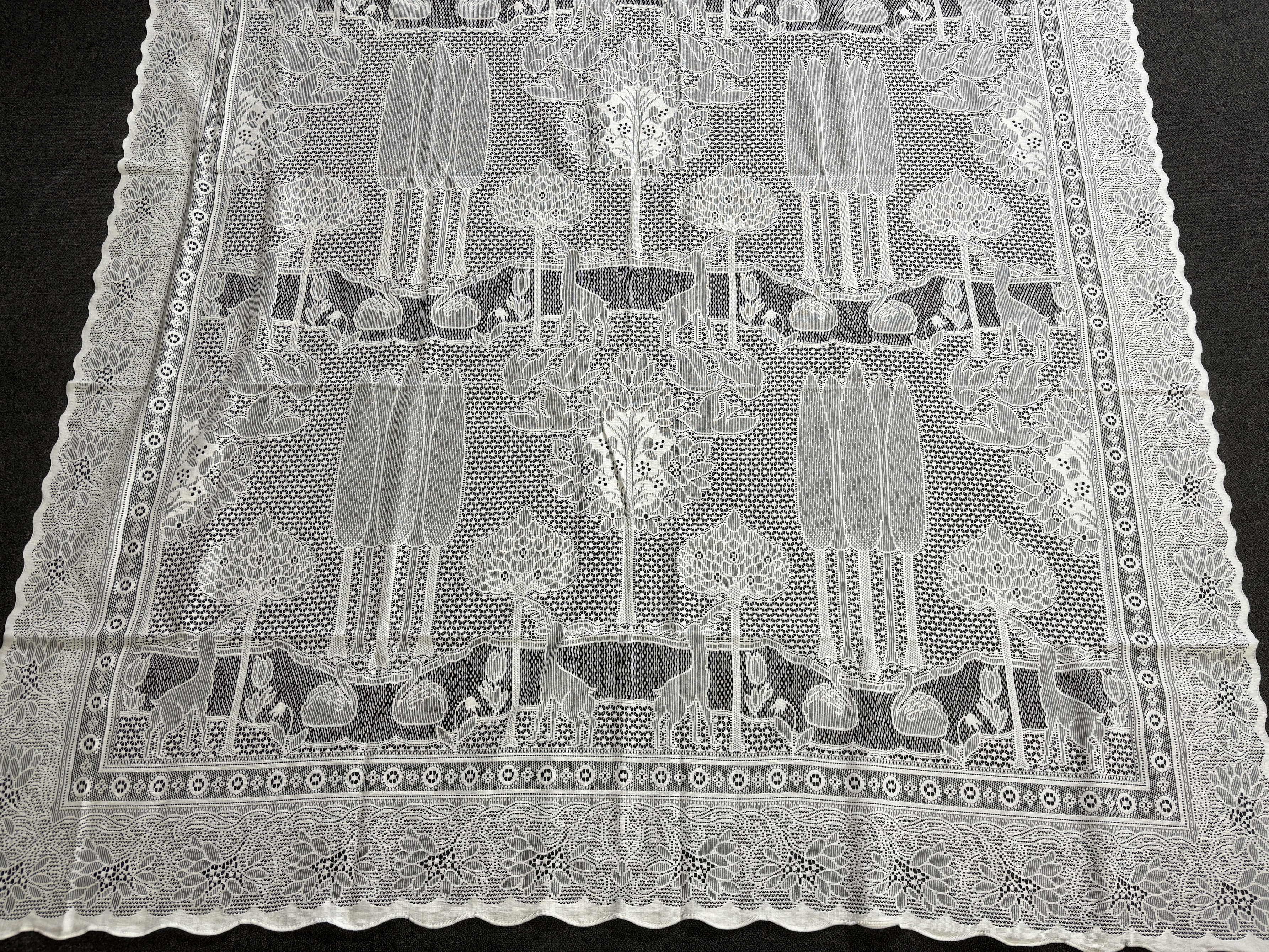 A set of three C.F.A. Voysey design “The Stag”, machine made, cotton lace curtains manufactured by Rose’s Mill Ltd, Ayrshire, unused, 180cm x 240cm